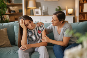 Mother comforting upset daughter