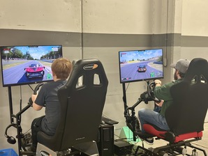 Father and son playing virtual racing game