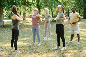 Group of older adults doing tai chi in the park