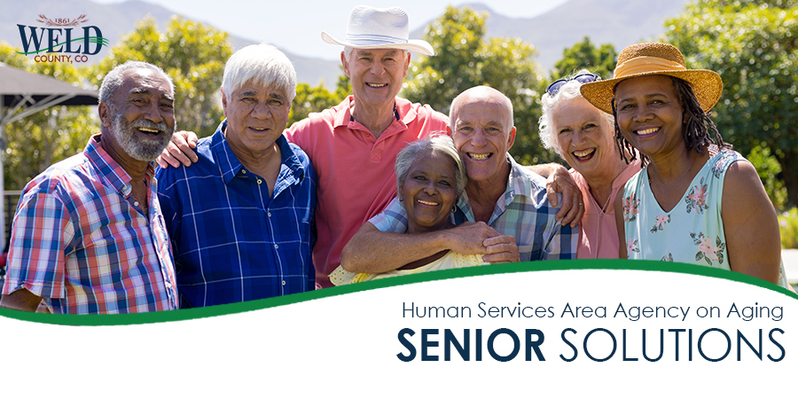 Group of happy older adults embracing and smiling in garden