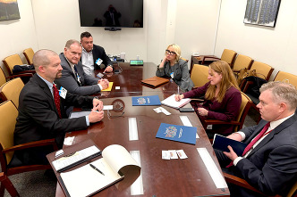 Commissioners sitting around a table with the Department of Energy 