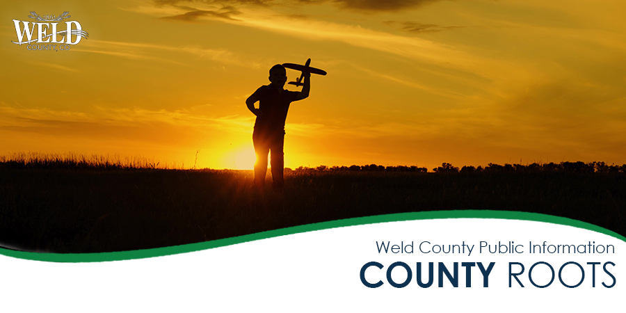 Silhouette of boy playing with a toy plane. Banner below reads "Weld County Public Information. County Roots."