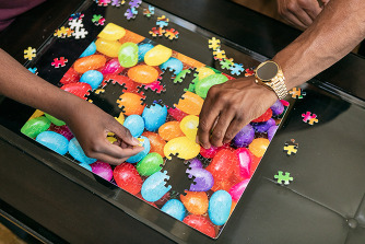 Father and son completing a puzzle together