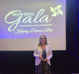 Esther Dennis, a Weld County foster parent, holds award received at Pinwheel Gala