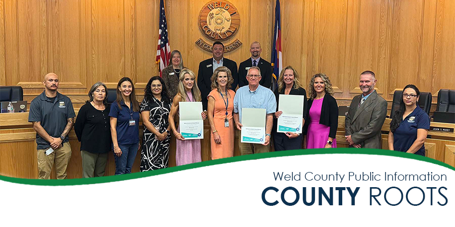 Weld County staff with awards at meeting