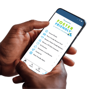 Hands holding a cellphone displaying the Foster Friendly app