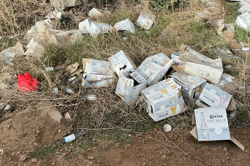 Boxes and trash in county right of way.