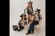 Members of Weld County Fair royalty smiling casually. 