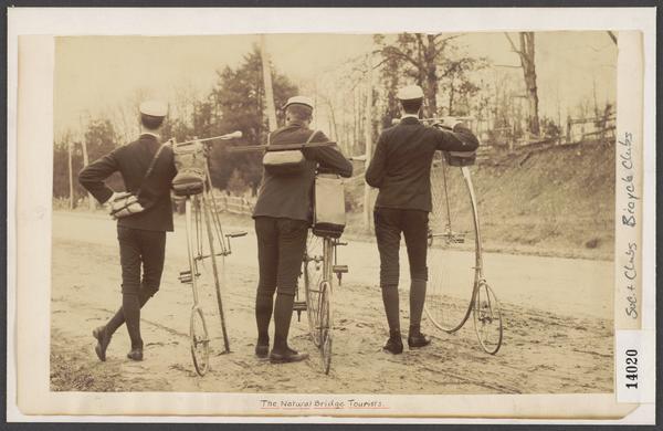 Capital Bicycle Club members Clarence G. Allen, Max Hansmann, and L. Warren Seely pose with their bicycles on the side of the road.