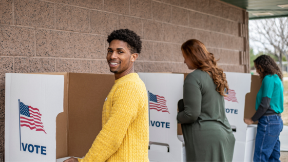 Photo of three people at voting booths