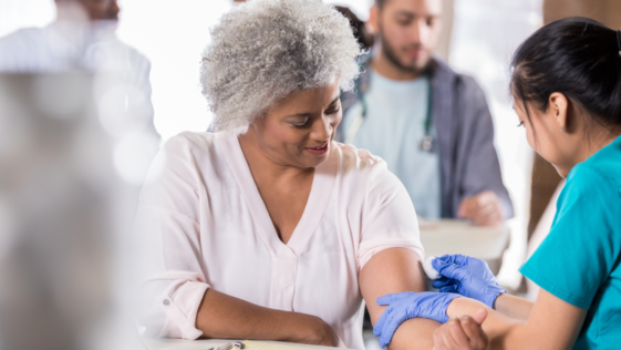 Nurse swabs a person with a cotton ball 