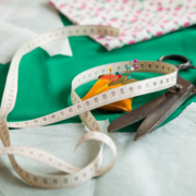 Sewing setup with pins, scissors, and soft measuring tape