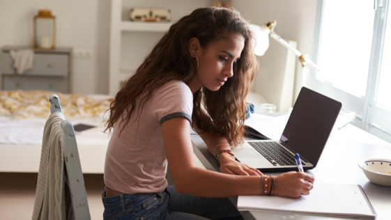 Teen writing a paper at a desk