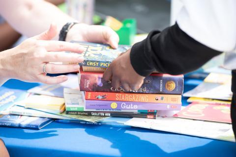 hands exchanging books