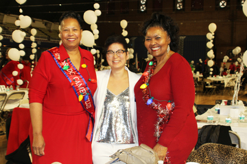 Image of Exec Director and Two seniors at the holiday event