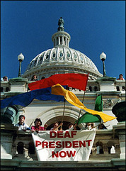 Flags are swung by Deaf activists infront of the Capitol 