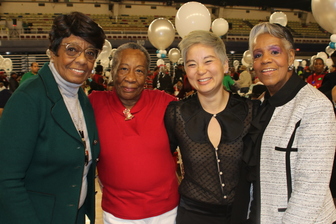 Executive Director Newland with seniors at the annual holiday celebration