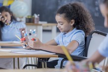 Student looking at a molecular model at a desk