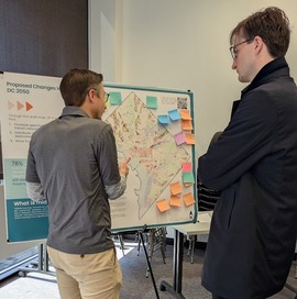 OP staff member speaks with an event attendee about the draft future land use map