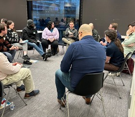Residents and OP staff participate in a small group discussion on housing policy
