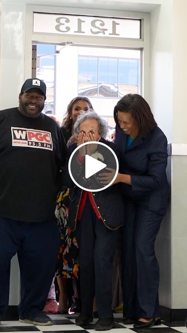 A video screenshot of Virginia Ali and Mayor Bowser entering the remodeled Ben's Chili Bowl