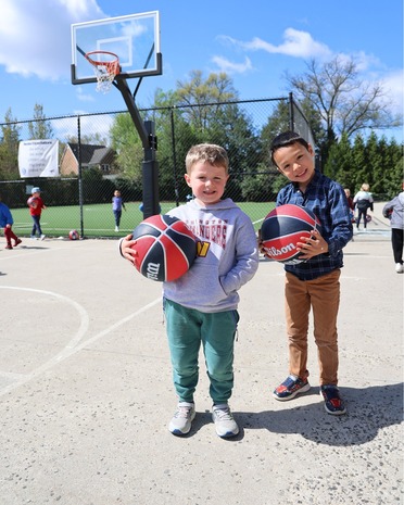 Two kids playing basketball at an afterschool program
