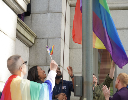 Mayor Bowser, leaders and community members raise the Pride flag outside of City Hall. 
