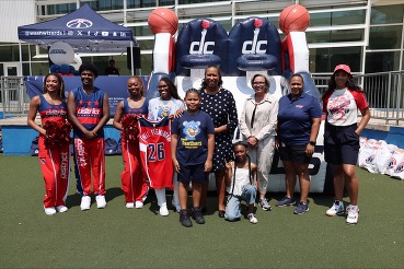 Photo of Mayor Bowser, students, Chancellor Jackson and Wizards representatives at Powell Elementary School. 