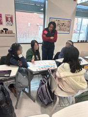 Photo from a high school event, featuring DC Office of Planning Director talking to some high school students