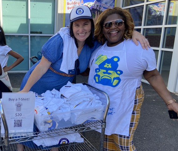 Two women selling T-shirts for the Barnard Elementary School PTA