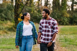 Couple holding hands on a walk in a park