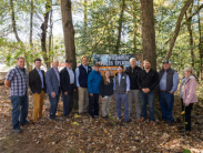 Group poses at celebration for Trap Pond splash park groundbreaking.