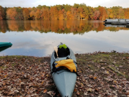 Kayak sitting on rocks overlooking water at Trap Pond State Park.