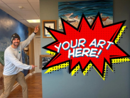 DNC staff poses next to "YOUR ART HERE!" sign