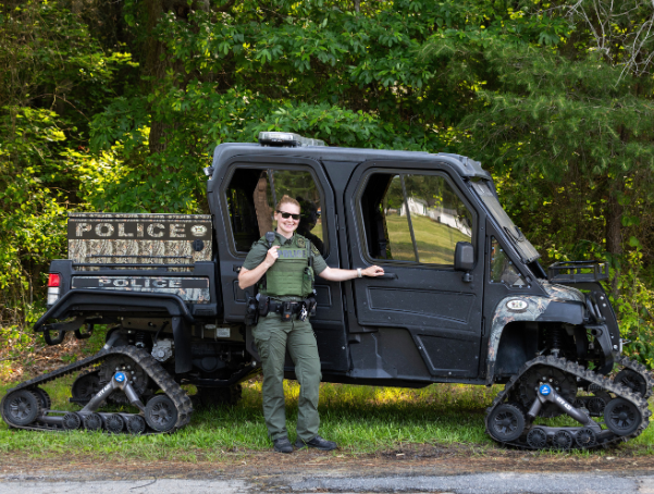 Lieutenant Rebecca Salmon standing with a DNRP gator. 