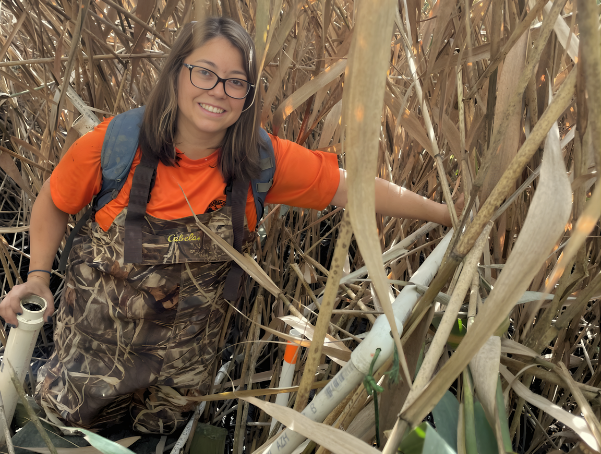 Mollie Yacano posing for a photo in a coastal area. 