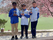 Arjun Nathan, Jialong Liu and Alexander Martian of H.B. du Pont Middle School hold trophies after winning the Solar Racer competition.