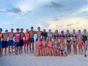 The Delaware Beach Patrol poses on a Fort Lauderdale beach following their third consecutive national championship title 