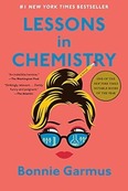 Book Cover: Lessons in Chemistry by Bonnie Garmus Image: Woman with hair in bun held by a pencil and chemistry equipment reflected in glasses