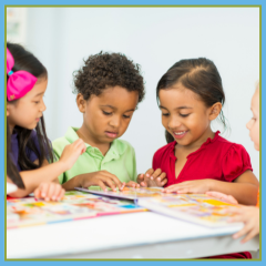 Young children sitting around a table looking at books