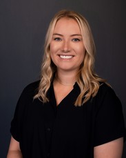 Calleigh Ross, person smiling with black shirt on a grey background