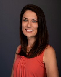 Samantha M, person in orange shirt smiling