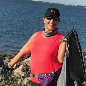 Volunteer holding trash bag full of litter