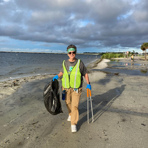 Volunteer cleaning up litter on beach