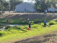 Group of people cleaning up a lake