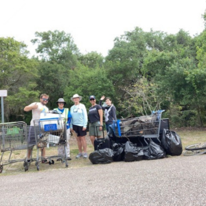 Group of people with shopping cart in park