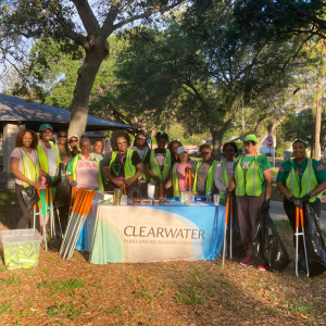 Group of women standing in front of table with litter pickup equipment