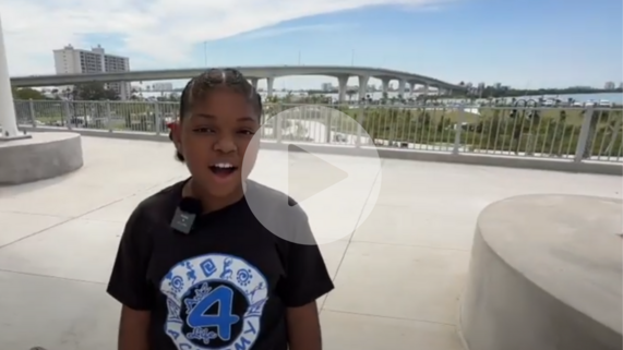 girl standing at the top of a park hill