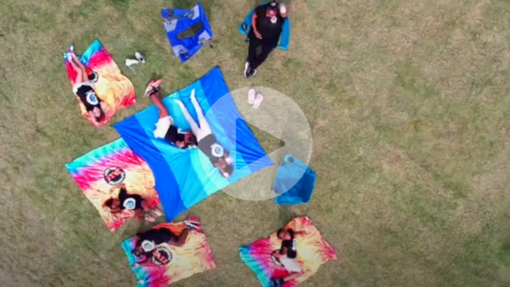 kids sitting on a blanket in a park