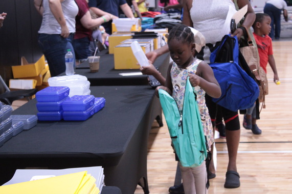 a person receiving a backpack